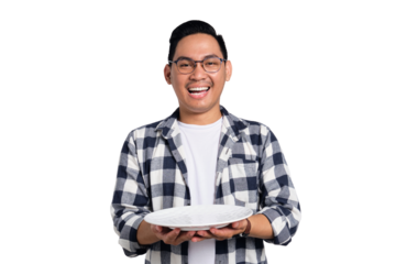 Happy young Asian man in casual shirt holding empty blank plate isolated on transparent background