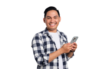 Smiling young Asian man in casual shirt using smartphone, chatting online, texting message, looking at camera isolated on transparent background