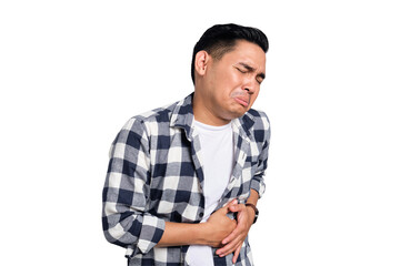 Abdominal Pain. Unhealthy young Asian man in casual shirt suffering from stomachache isolated on...
