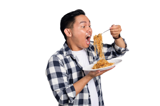 Happy young Asian man in casual shirt enjoying eating noodles with fork isolated on transparent background