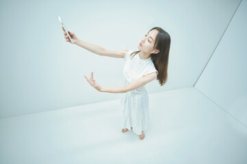 スマートフォンを持ちながら舞う若い女性
