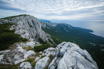 Fototapeta premium Dramatic Coastal Mountain Peak Landscape Serene Ocean View from Rocky Summit
