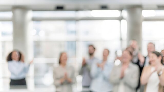 Defocused crowd with joyful expressions applauding speaker at professional event
