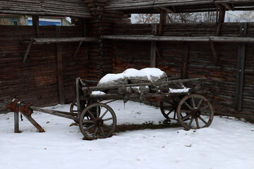 an old cart loaded with sacks stands near the wooden walls of the fortress