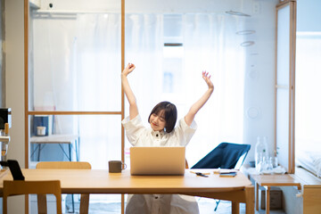 在宅での仕事中に深呼吸する女性