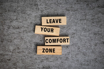 leave your comfort zone words on wooden blocks isolated on grey surface