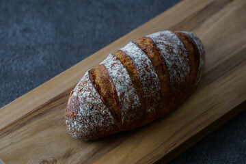 黒いテーブルの上に置かれたパンとカッティングボード