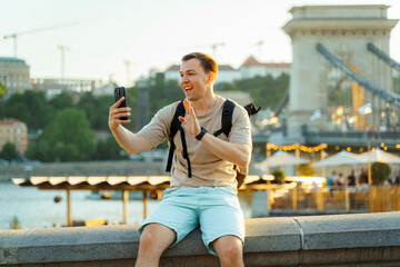 Happy Tourist Video Calling from Budapest with Chain Bridge in Background