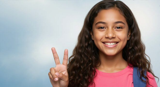Smiling girl with wavy dark hair showing peace sign with blue backpack. Positive student attitude for elementary education and school success programs