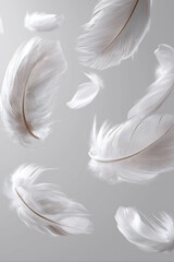 Naklejka premium White soft feathers flying on the air symbol of softness and purity on light background