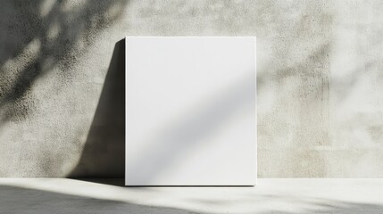 Blank canvas mockup against a textured wall with sunlight shadows.
