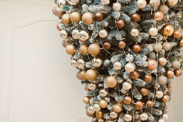 A stunning upsidedown Christmas tree that is beautifully adorned with elegant and shimmering gold...