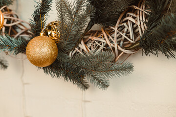 A beautifully and elegantly decorated Christmas wreath, adorned with stunning gold ornaments and...