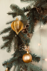 The Elegant and Beautiful Christmas Ornaments are delicately hanging on a lush Pine Tree adorned with Glowing Lights, creating a warm and cheerful atmosphere perfect for the festive celebration