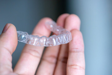  clear aligners device in the mouth on a white background. (invisalign)