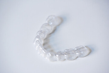  clear aligners device in the mouth on a white background. (invisalign)