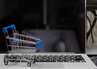 close up of Cart on keyboard computer with tablet background (Online shopping)