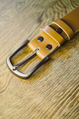 This is a beautifully stylish brown leather belt that features a durable metal buckle, expertly...