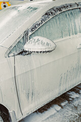Car Wash Process Vehicle Coated in Foam for a Thorough Cleaning