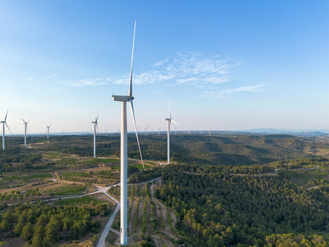 Elevated aerial view of multiple wind turbines in Terra Alta, Catalonia, Spain, highlighting renewable energy sources and green environmental practices