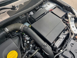 A closeup view of a modern automotive engine compartment, showcasing essential components like the...