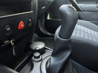 This image shows a closeup of the cars interior, focusing on the gear shift and controls that...
