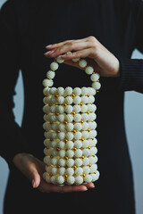 Discover the Elegant PearlEmbellished Handbag that features a Unique and eyecatching design,...