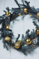 This beautiful and elegant Christmas wreath is decorated with stunning golden ornaments and frosted...