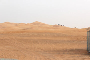 Dubai desert safari in sunset light. Off road safari in sand desert, Empty Quarter Desert in United Arab Emirates. Off roader on dunes in Rub al Khali desert.