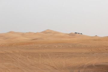 Dubai desert safari in sunset light. Off road safari in sand desert, Empty Quarter Desert in United Arab Emirates. Off roader on dunes in Rub al Khali desert.