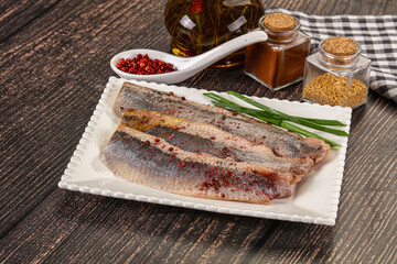 Salted marinated herring fillet with spices