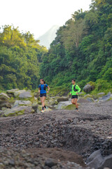 Asian Indonesian couple trail running near Merapi volcano, active sport and sustainable lifestyle