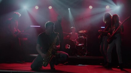 Saxophonist performing live with band in slow motion