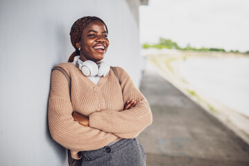 Portrait of young happy black woman with dental braces. She is looking away and smiling.
