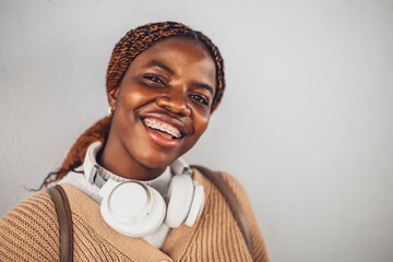 Portrait of young happy black woman with dental braces. She is looking at camera and smiling.