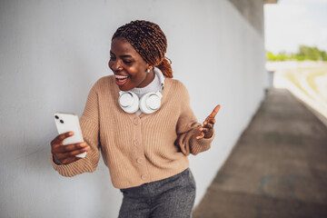 Portrait of young black woman who is having video call on smartphone.