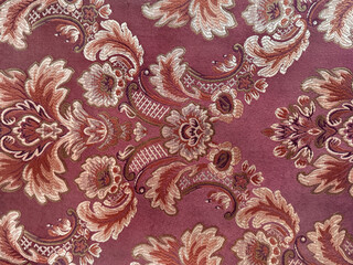 Close up of classic ornamental fabric in random floral, leaves, and damask pattern. Wallpaper and...