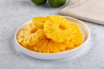 Sweet canned pineapple slices in syrope