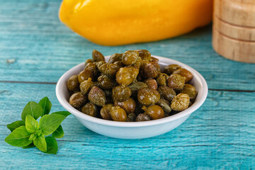 Pickled canned capers in the bowl