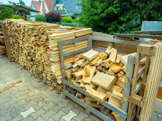 The neatly stacked firewood along with cut lumber in a designated storage area creates a...