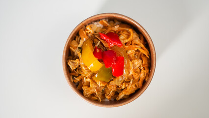Delicious Stir-fried Noodles with Bell Peppers in a Brown Paper Bowl