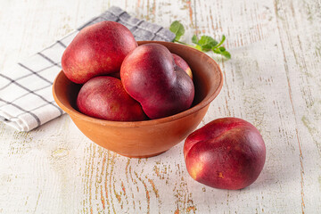 Ripe sweet juicy flat nectarines heap