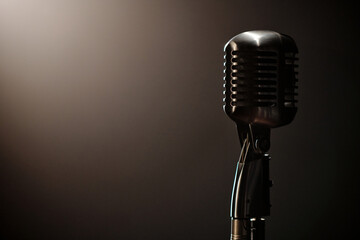 Vintage microphone standing on stage with dramatic lighting, classic equipment used by jazz...