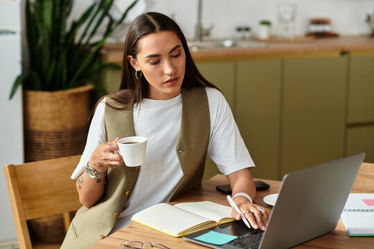 Young pretty woman enjoying a cozy day at home while working on her laptop