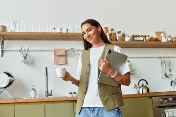 Young woman enjoying her cozy home environment while sipping coffee and working on a tablet