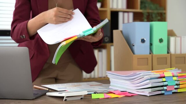 Office Organizer: A business professional organizes paperwork and documents in a modern office. Highlighting organizational skills, focus, and productivity. 