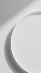 Curved Ceramic Plate on Light Gray Background with Soft Top-Down Lighting