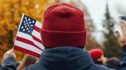 Crowd of spectators at a Veterans Day parade, waving flags in support