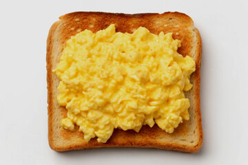 A delicious serving of scrambled eggs perfectly placed on a slice of toast