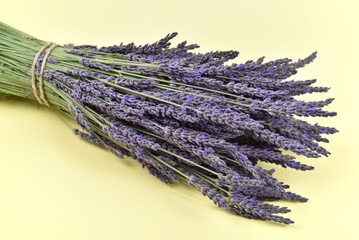 Bouquet of lavender flowers on the yellow background.  Close-up. Copy space.